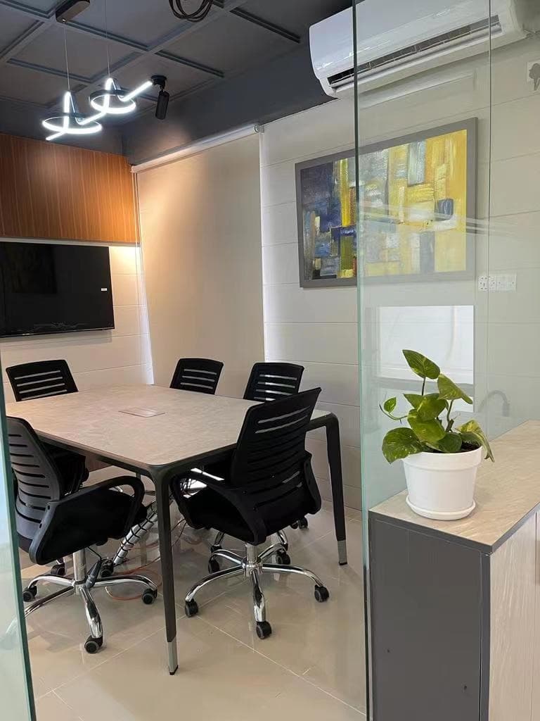 Compact Meeting Room with Wall Art and Pendant Lighting